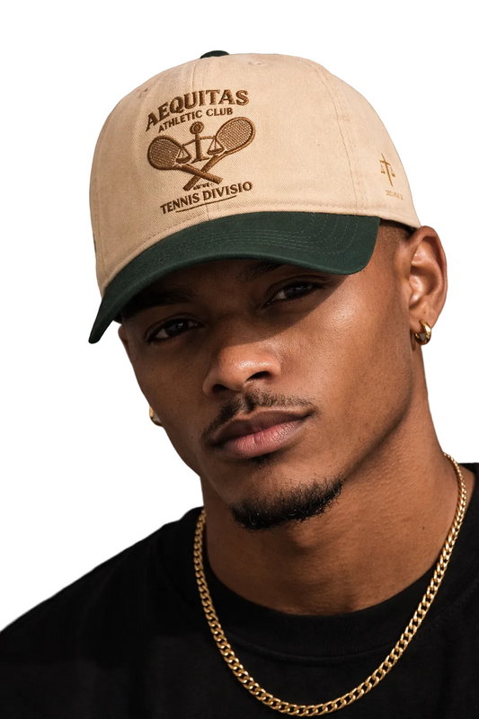 Man wearing a beige cap with 'Aequitas Tennis Division' logo against a brown background