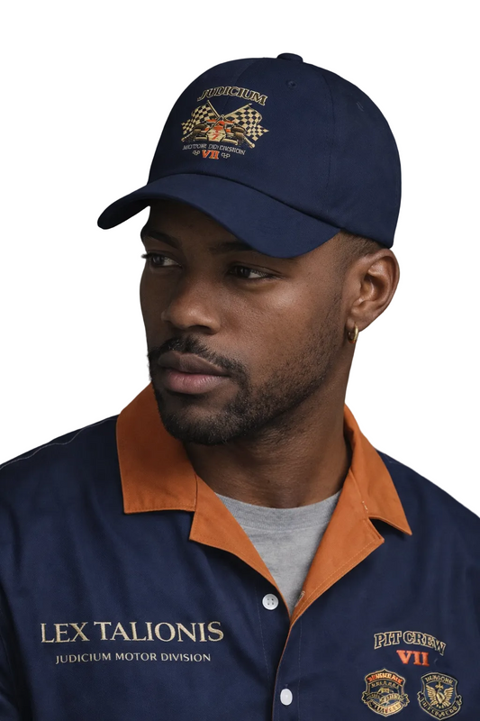 Man wearing a navy cap and matching jacket with logos on a gray background