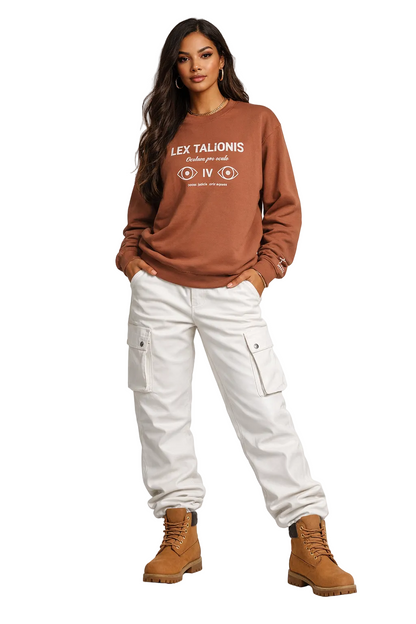 Woman wearing a brown sweatshirt with text, white cargo pants, and brown boots on a white background