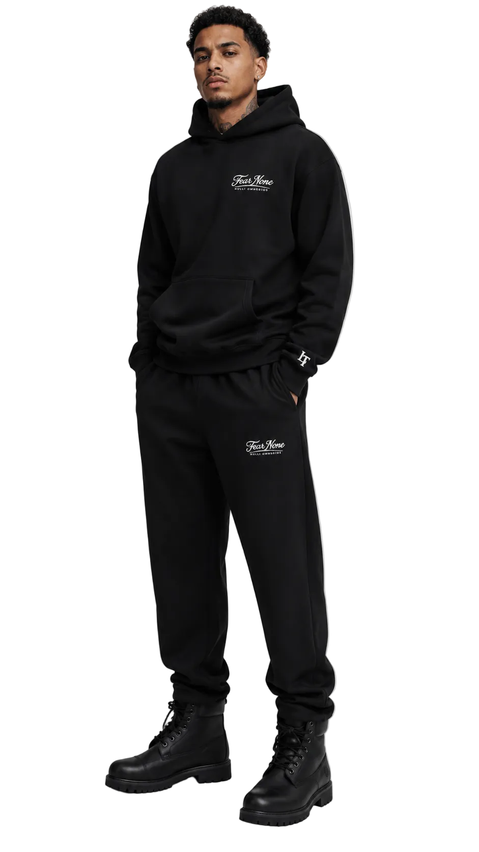 Person wearing a black hoodie and pants with brand logos on a white background
