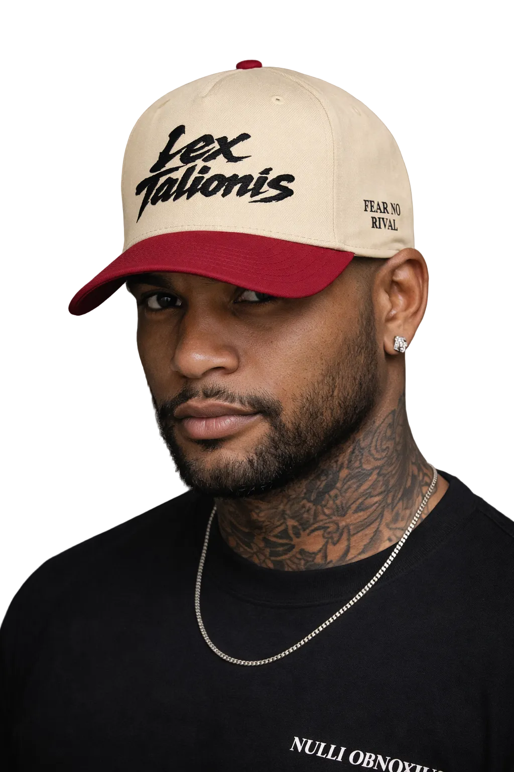 Man wearing a beige and red cap with text, against a gray background