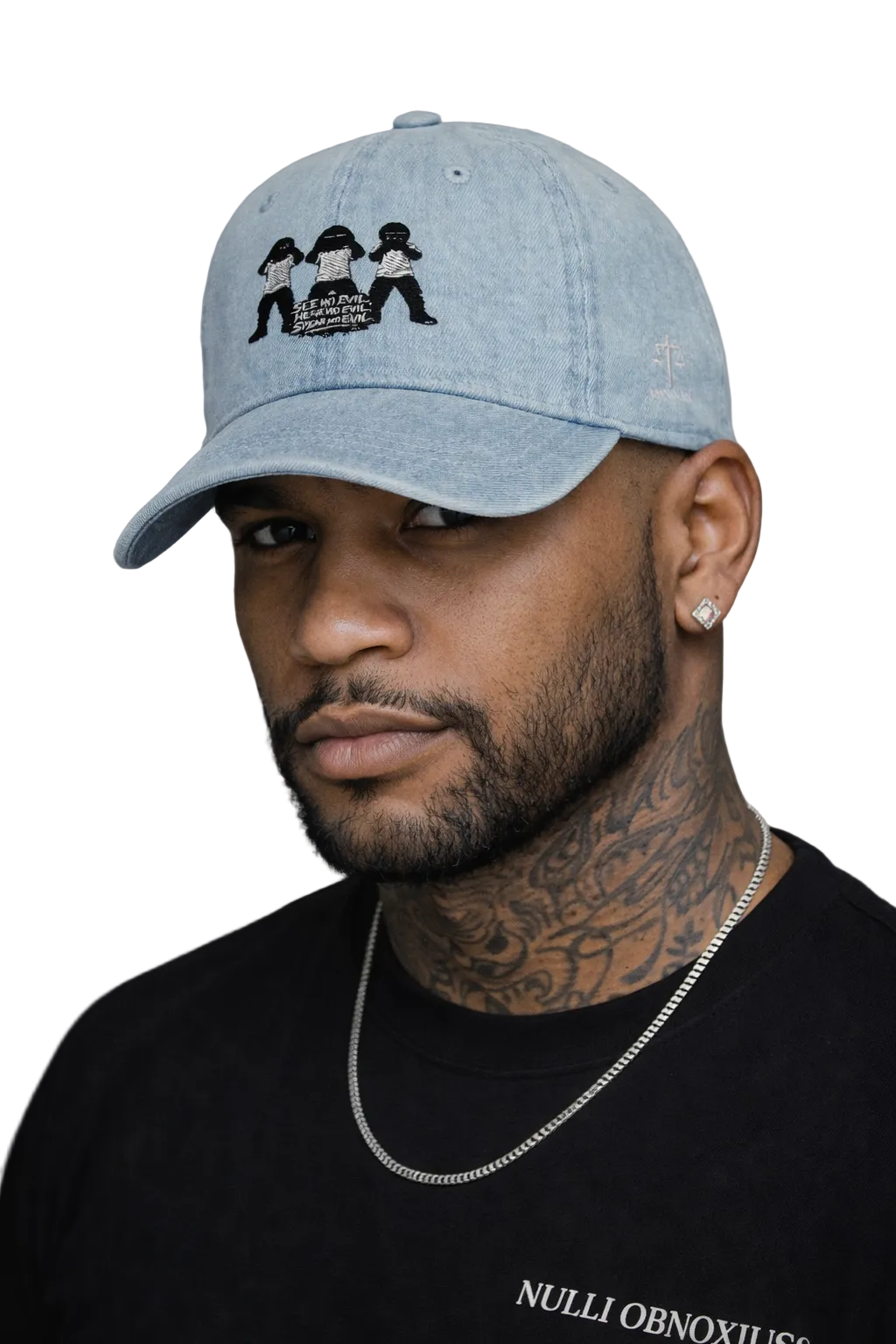 Man wearing a light blue cap with a logo and black shirt against a gray background