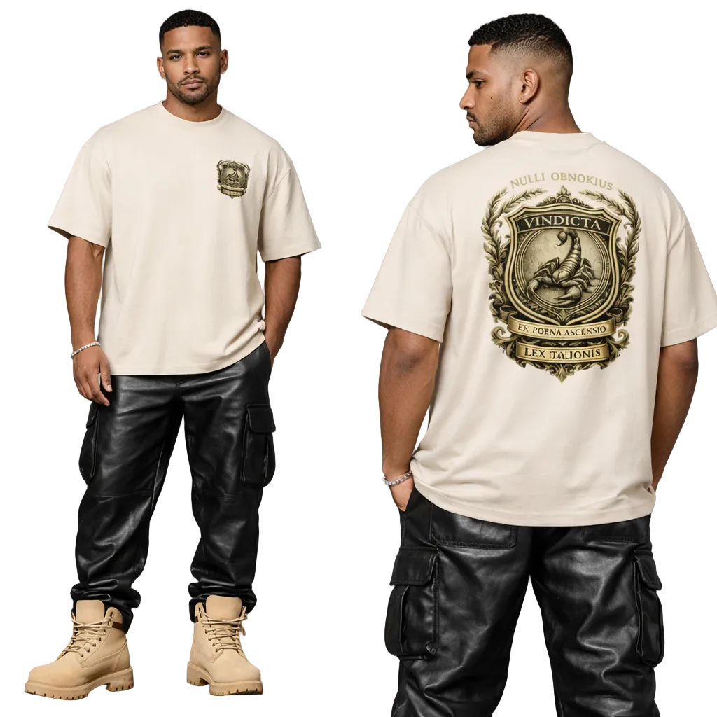 Man wearing a beige t-shirt with a logo on the front and back, standing against a gray background.