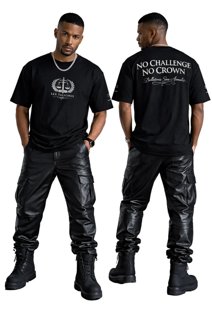 Man wearing a black t-shirt with text and logo, standing in a minimalistic room.