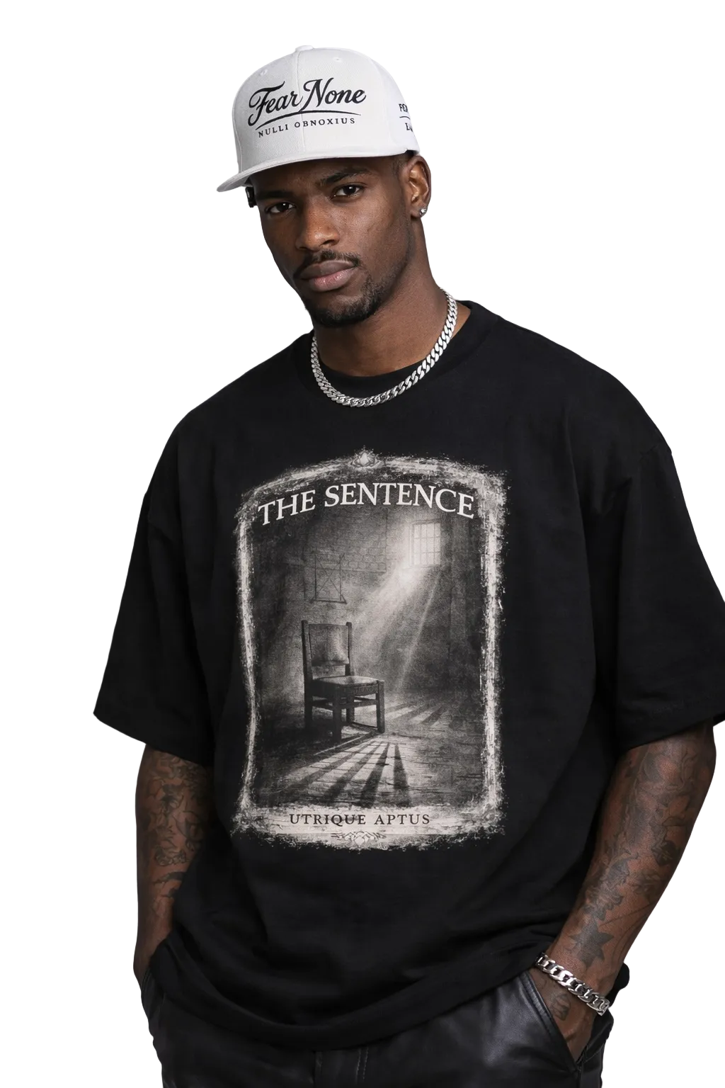 Man wearing a black t-shirt with a graphic design and a white cap on a gray background