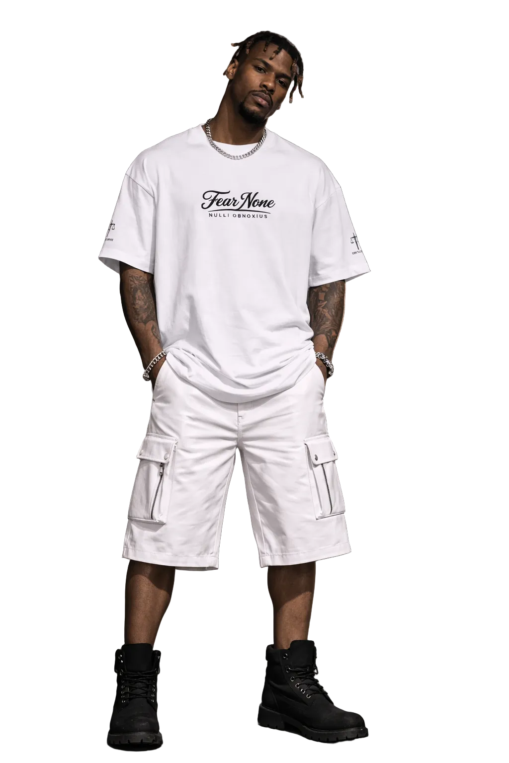 Man wearing a white t-shirt and cargo shorts with 'Fear None' text, standing in an urban setting.