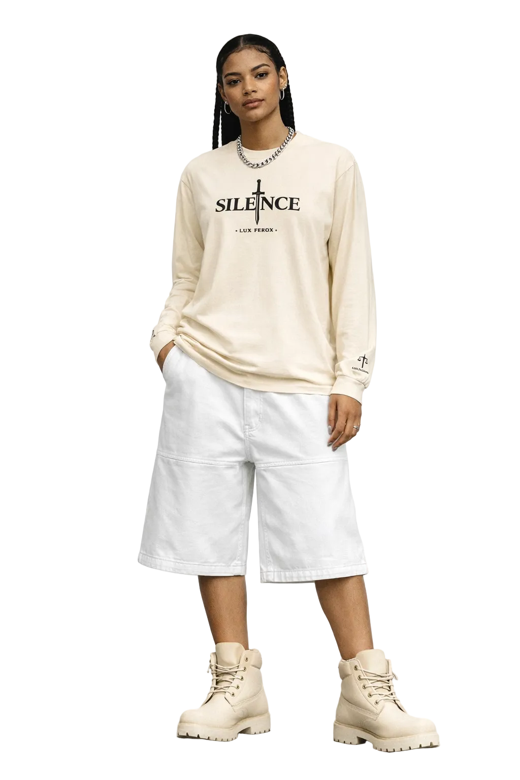 Person wearing a beige long-sleeve shirt with text and white pants against a plain background