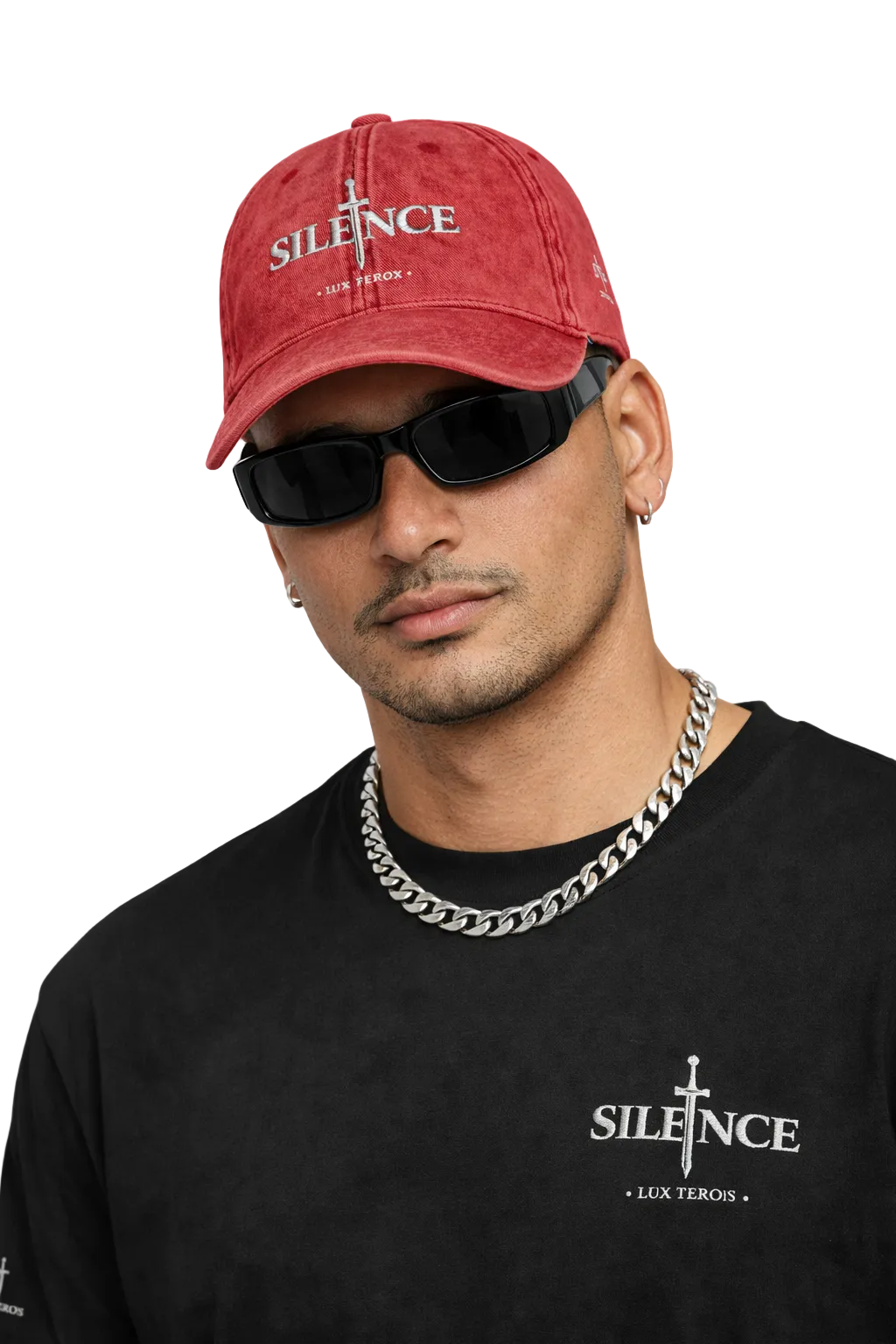 Man wearing a red cap and black sunglasses with 'SILENCE' branding on clothing against a light gray background.