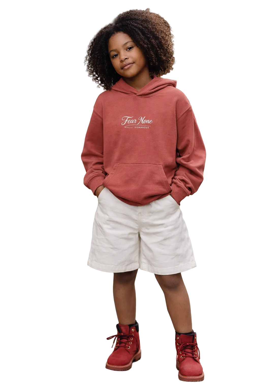 Child wearing a red hoodie with text, white shorts, and red boots on a sidewalk.