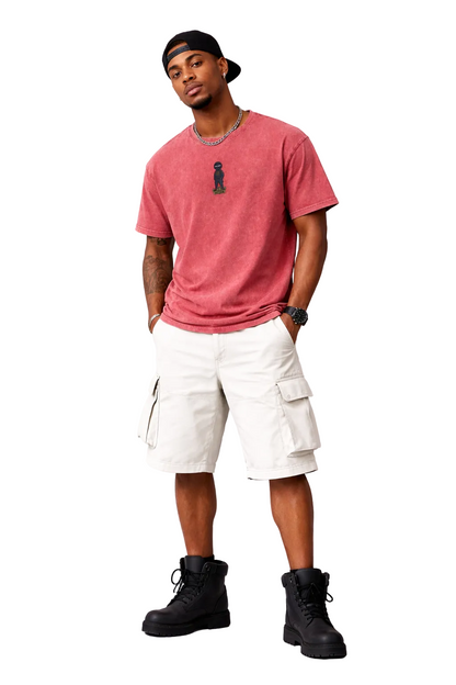 Man wearing a red t-shirt, white cargo shorts, and black boots on a white background