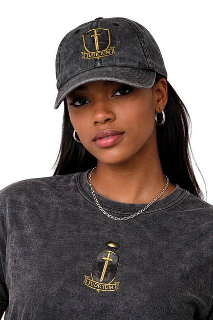 Woman wearing a dark gray cap and t-shirt with a logo on a white background