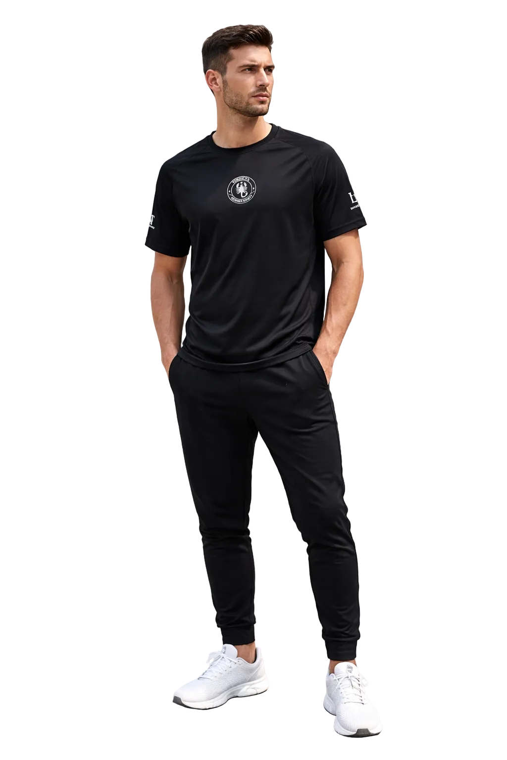 Man wearing a black t-shirt and pants standing on steps with a gray wall background