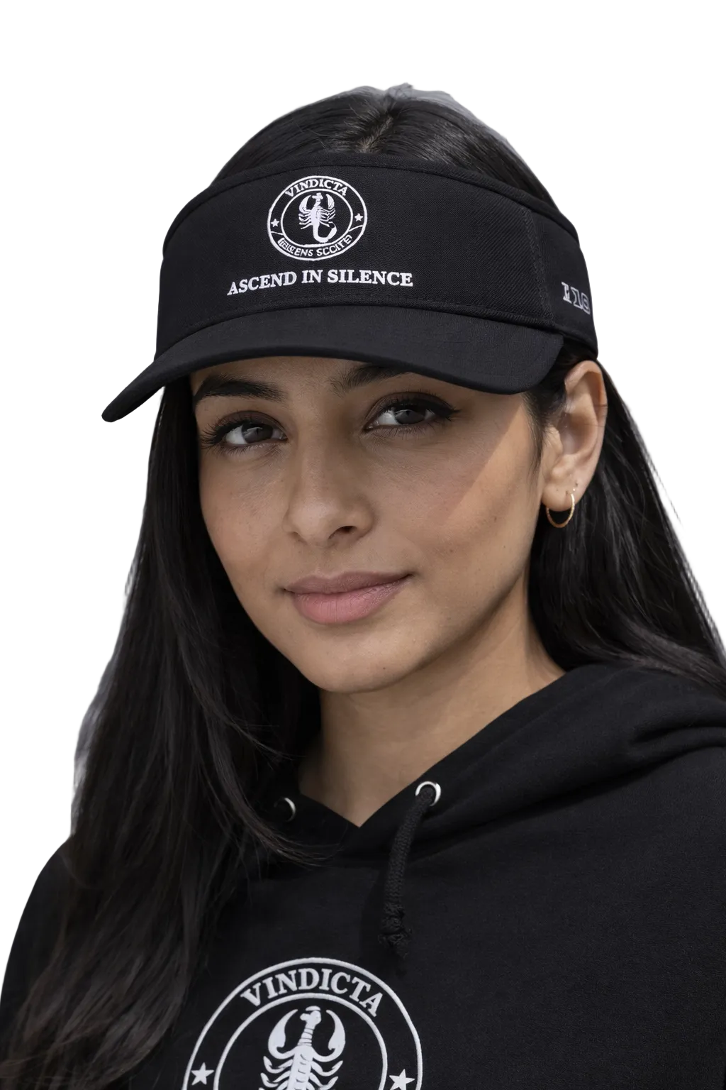 Person wearing a black cap and hoodie with 'Vindicta' logo against a gray background