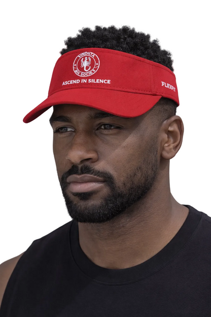 Man wearing a red cap with text, standing against a neutral background