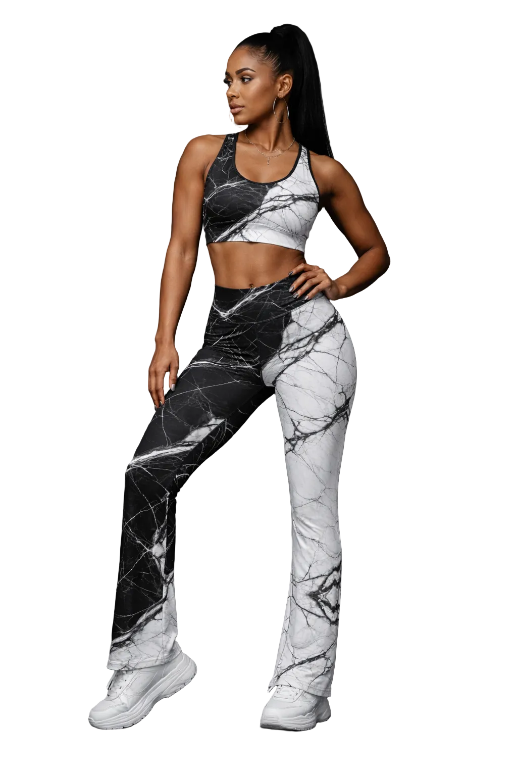 Woman wearing a black and white marble patterned outfit on a dark background