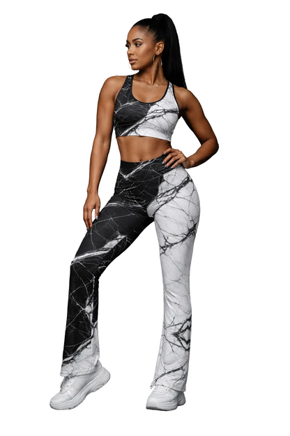 Woman wearing a black and white marble patterned outfit on a dark background