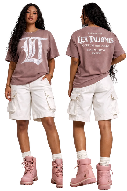 Woman wearing a brown t-shirt with white text and white cargo shorts, standing against a white background.