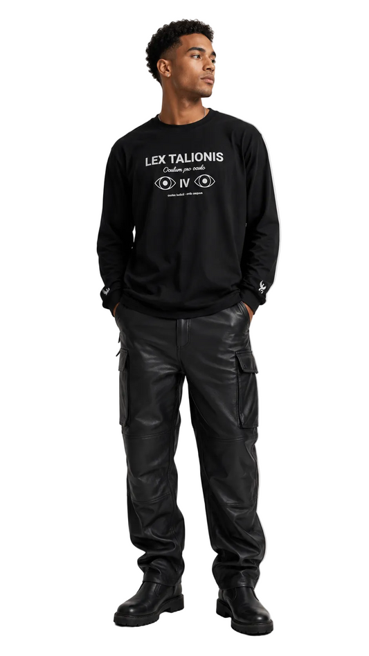 A man wearing a black crewneck sweatshirt with white graphic text and cargo pants, standing against a light gray studio background.