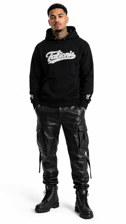 Person wearing a black hoodie with 'Falkor's' logo and black leather pants on a white background