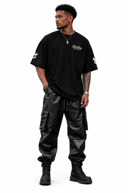 Man wearing a black t-shirt and cargo pants on a white background