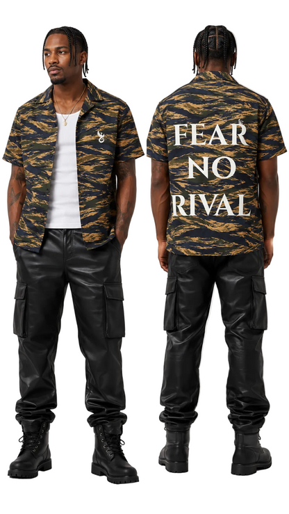 A model shown from the front and back wearing a short-sleeve camouflage button-up shirt with 'FEAR NO RIVAL' printed in white across the back, paired with black cargo pants and black boots, on a light gray background.