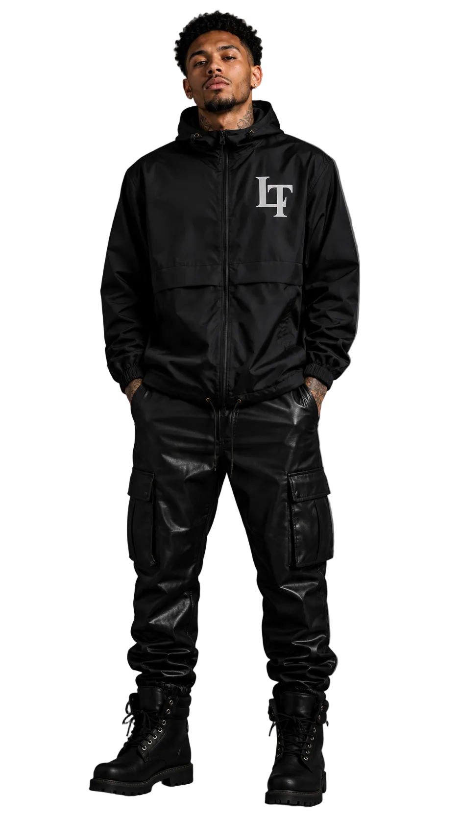 Person wearing a black jacket with a logo and cargo pants on a gray background
