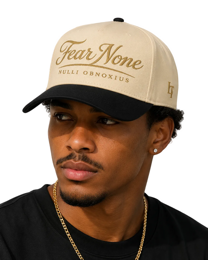 Man wearing a beige cap with 'Fear None' text on a plain background
